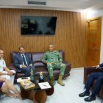 Director General in camouflage uniform, together with the Ombudsman, officials and a Navy officer, gathered in the office with the national coat of arms and a screen in the background.