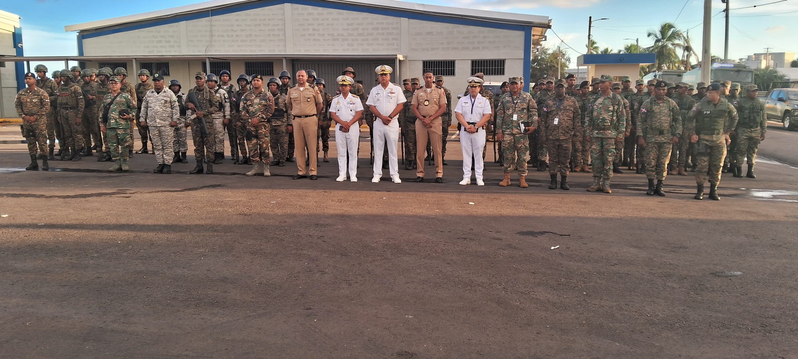 General Manager in Haina with military personnel posing all facing each other in military formation