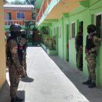 Army personnel standing outside a hotel