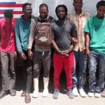 Undocumented foreigners detained in front of immigration control truck