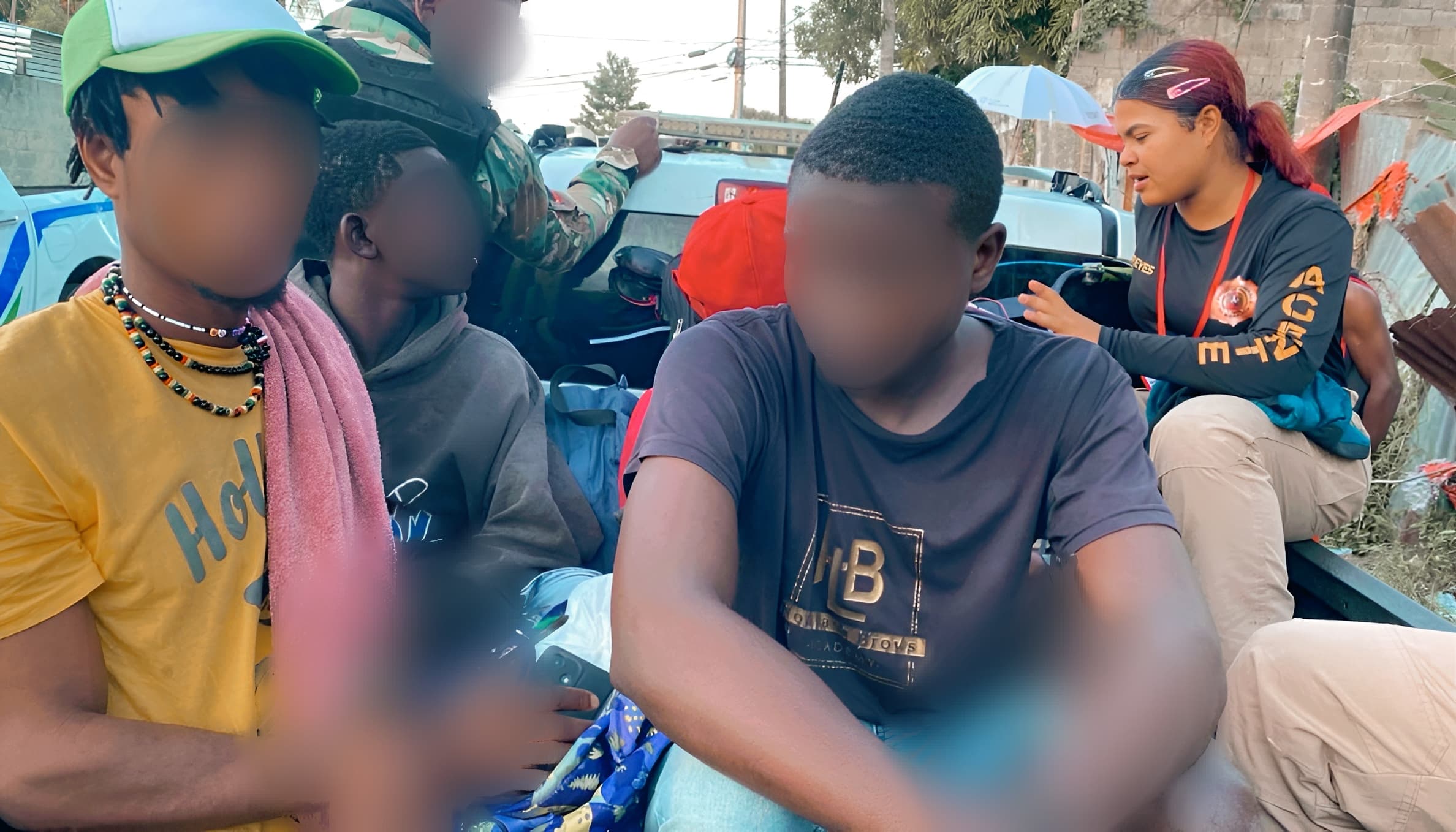 Illegal aliens detained riding in a van, sitting.