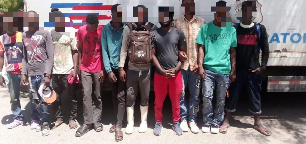 Illegal foreigners detained, all standing in front of an immigration