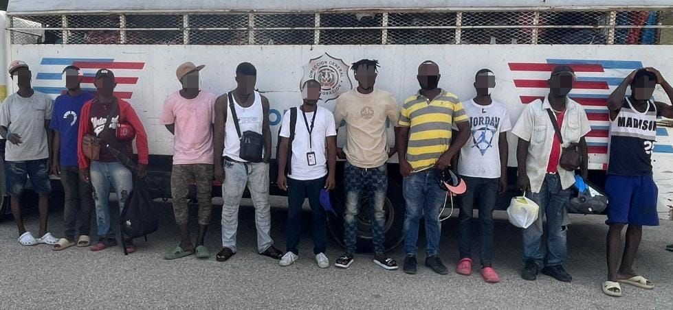 Illegal foreigners detained, all standing in front of an immigration